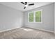 Inviting bedroom with a ceiling fan, large window and natural light, creating a cozy atmosphere at 154 Buckaroo Dr, Louisburg, NC 27549