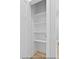Neat linen closet with wooden-style floor and multiple white shelves at 154 Buckaroo Dr, Louisburg, NC 27549