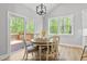 Dining area with views of nature, featuring a round wooden table and comfortable seating at 154 Buckaroo Dr, Louisburg, NC 27549