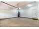 Spacious garage with concrete floors, ample lighting, and utility equipment at 154 Buckaroo Dr, Louisburg, NC 27549