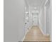Bright hallway featuring light walls, wood flooring and white doors at 154 Buckaroo Dr, Louisburg, NC 27549
