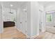 Bright hallway leading to multiple rooms, showcasing modern flooring and neutral wall colors at 154 Buckaroo Dr, Louisburg, NC 27549