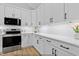 Modern kitchen with white cabinets, stainless steel appliances, and quartz countertops at 154 Buckaroo Dr, Louisburg, NC 27549