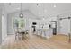 Bright kitchen with white cabinets, stainless appliances, and a dining area with large windows at 154 Buckaroo Dr, Louisburg, NC 27549
