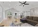 Open concept living space with white kitchen, vaulted ceilings, hardwood floors and modern furniture at 154 Buckaroo Dr, Louisburg, NC 27549