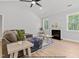 Cozy living room with hardwood floors, a fireplace and ample natural light at 154 Buckaroo Dr, Louisburg, NC 27549