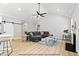Spacious living area with hardwood floors, a vaulted ceiling, and modern furnishings at 154 Buckaroo Dr, Louisburg, NC 27549