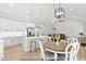 Bright open concept features modern kitchen, dining table, and a cozy living room with ample seating at 154 Buckaroo Dr, Louisburg, NC 27549