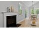 Living room featuring a fireplace, hardwood floors, and a dining area with sliding glass door at 154 Buckaroo Dr, Louisburg, NC 27549