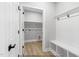Convenient mudroom area with storage bench and coat hooks adjacent to the laundry room at 154 Buckaroo Dr, Louisburg, NC 27549