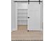 Walk-in pantry with a sliding barn door offers ample storage space and easy access to shelving at 154 Buckaroo Dr, Louisburg, NC 27549