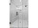 Spacious shower with marble-look tile, glass enclosure, built-in bench, and overhead shower head at 154 Buckaroo Dr, Louisburg, NC 27549