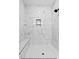 Detailed view of a shower showcasing marble-look tiling, seating, and modern shower fixtures at 154 Buckaroo Dr, Louisburg, NC 27549