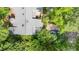 Aerial view of a home showing a roof with skylights and lush landscaping at 16 Tottenham Ln # 16, Chapel Hill, NC 27517