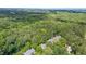 Drone shot showing rooftops within a tree-filled neighborhood at 16 Tottenham Ln # 16, Chapel Hill, NC 27517