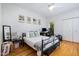 Bright bedroom features hardwood floors, ceiling fan, and a large window at 16 Tottenham Ln # 16, Chapel Hill, NC 27517
