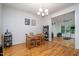 Charming dining room featuring hardwood floors and a traditional chandelier, seamlessly connected to other living spaces at 16 Tottenham Ln # 16, Chapel Hill, NC 27517