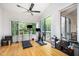 Bright exercise room with hardwood floors, large windows and workout equipment at 16 Tottenham Ln # 16, Chapel Hill, NC 27517
