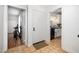 Hallway with tile floor, white door, leading to kitchen and exercise area at 16 Tottenham Ln # 16, Chapel Hill, NC 27517