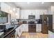 Modern kitchen featuring stainless steel appliances, granite countertops, and ample cabinet space for storage and cooking at 16 Tottenham Ln # 16, Chapel Hill, NC 27517