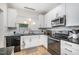 Well-lit kitchen featuring granite countertops, stainless steel appliances, and stylish cabinetry for a modern aesthetic at 16 Tottenham Ln # 16, Chapel Hill, NC 27517