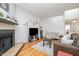 Bright living room featuring hardwood floors, a cozy fireplace, and neutral decor, creating an inviting atmosphere at 16 Tottenham Ln # 16, Chapel Hill, NC 27517