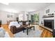 Open-concept living room with a fireplace, hardwood floors, and access to outdoor seating, perfect for entertaining at 16 Tottenham Ln # 16, Chapel Hill, NC 27517