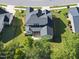 Aerial view showing a spacious backyard with a screened porch, patio, and landscaped surroundings at 1612 Commons Ford Pl, Apex, NC 27539