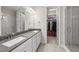 Bathroom with a double sink vanity, walk-in shower, and a view into the walk-in closet at 1612 Commons Ford Pl, Apex, NC 27539