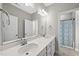 Bright bathroom featuring double vanity with stylish mirrors and a shower with a decorative shower curtain at 1612 Commons Ford Pl, Apex, NC 27539