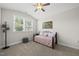 Cozy bedroom with a ceiling fan, a window letting in natural light, and stylish decor at 1612 Commons Ford Pl, Apex, NC 27539