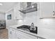 Well-appointed kitchen boasts granite countertops, modern appliances, and stylish tile backsplash at 1612 Commons Ford Pl, Apex, NC 27539