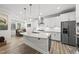 Bright, spacious kitchen featuring an island, stainless appliances, and seamless dining room access at 1612 Commons Ford Pl, Apex, NC 27539