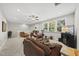 Cozy and well-lit upstairs living room with a comfortable seating arrangement and large windows at 1612 Commons Ford Pl, Apex, NC 27539