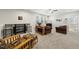 Spacious living room area featuring comfortable furniture, a bar area, and large windows at 1612 Commons Ford Pl, Apex, NC 27539