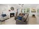 Cozy living room featuring a fireplace, comfortable seating, and ample natural light at 1612 Commons Ford Pl, Apex, NC 27539
