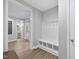 Mudroom with a built-in bench, storage cubbies, and hardwood floors at 1612 Commons Ford Pl, Apex, NC 27539