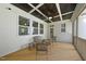 Relaxing screened porch with a paneled ceiling, ceiling fan, and comfortable seating arrangements at 1612 Commons Ford Pl, Apex, NC 27539