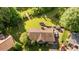 Aerial view of property showing fenced-in yard, deck, storage shed and mature trees at 1641 Regency Dr, Burlington, NC 27215
