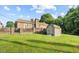 Backyard shed, fenced yard, brick patio at 1641 Regency Dr, Burlington, NC 27215