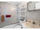 Cozy bathroom with shower-tub combo with sliding door and shelving for extra storage at 1641 Regency Dr, Burlington, NC 27215