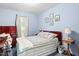 Well-lit bedroom featuring natural light, bedside table, and soft blue paint at 1641 Regency Dr, Burlington, NC 27215