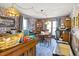 Dining room with vintage lighting, rustic wallpaper, and space for a bar area at 1641 Regency Dr, Burlington, NC 27215