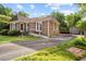 Side view of brick home featuring a ramp, driveway, and storage shed at 1641 Regency Dr, Burlington, NC 27215