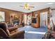 Warm and inviting Gathering room with a brick fireplace and wood paneled walls at 1641 Regency Dr, Burlington, NC 27215