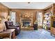 Cozy Gathering room with a brick fireplace, built-in shelves, and a comfortable seating arrangement at 1641 Regency Dr, Burlington, NC 27215