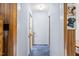 Hallway with wood trim, blue carpet, and decorative dog art on the wall at 1641 Regency Dr, Burlington, NC 27215