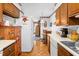 Traditional kitchen features wood cabinets, laminate countertops, and view to the breakfast nook at 1641 Regency Dr, Burlington, NC 27215