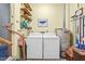 Laundry room with washer, dryer, shelving for storage, and water heater at 1641 Regency Dr, Burlington, NC 27215