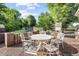 Enjoy outdoor living on this brick patio with its decorative table and chairs at 1641 Regency Dr, Burlington, NC 27215